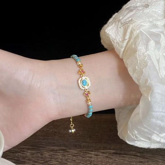 Bracelet with colourful beads on a wrist against a dark background