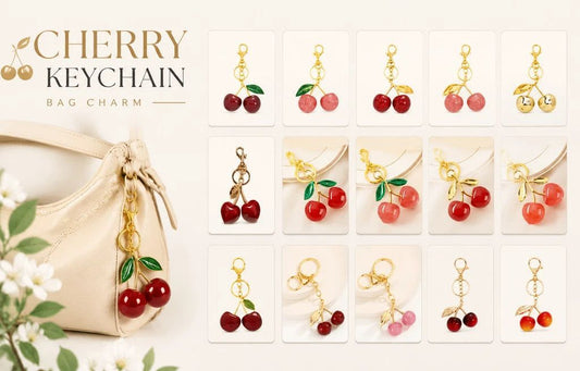 Cherry bag charm keychain set displayed on a cream handbag, with multiple small product variants arranged in a grid. The charms feature red cherry beads, green leaves, and gold-tone metal loops, with some variants including pink cherries or pearl-like accents.