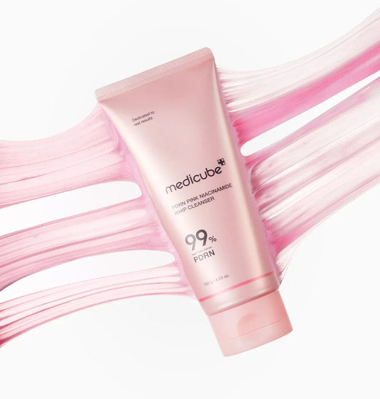 Pink tube of Medicube cleanser with pink abstract background