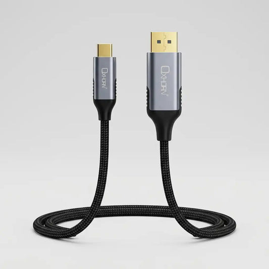 A black braided USB-C to USB-A cable with a silver and black connector housing and gold-plated metal contacts, featuring the 'Oxron' brand name printed vertically on the USB-C end.