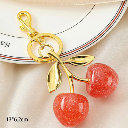 Delicate Pink Cherry Keychain with twin gold leaves, adding soft romantic glow to every bag you carry
